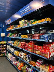 a store shelf filled with lots of different types of food at Hotel Centro Fashion in Fortaleza
