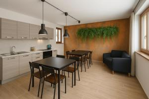 a kitchen and dining room with a table and chairs at B&B Bosco Ralle - comfort e natura in Satriano di Lucania