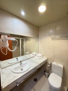 a bathroom with a sink and a toilet at Hostal Mediterranea in Madrid