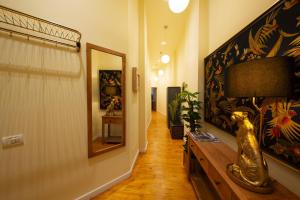 a hallway with a mirror and a lamp on a wall at Rainforest Studio Downtown by Pretty Apartments in Bucharest