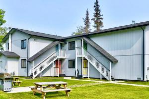 a building with a picnic table in front of it at Classic AK Townhome 2BR 2BA in Kenai