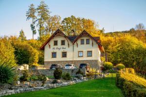 a house on a hill with cars parked in the yard at Na kraji lesa in Valašské Meziříčí