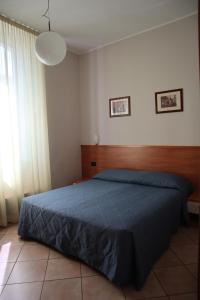 Postel nebo postele na pokoji v ubytování Albergo Salerno