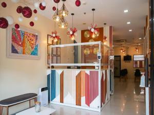 a room with a partition with colorful items on the wall at Super OYO 832 The Teepee Place Hostel & Residence Inn in Cebu City