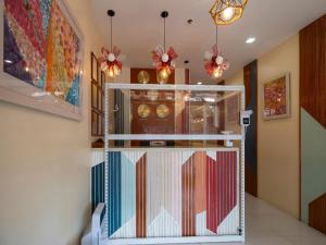a room with a display case with colorful artwork at Super OYO 832 The Teepee Place Hostel & Residence Inn in Cebu City +49 photos