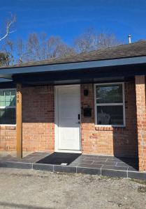 a brick house with a white door and a window at 2 Bdrm Downtown in Houston +11 photos