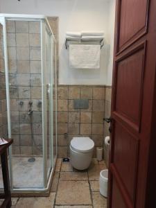 a bathroom with a toilet and a glass shower at KEYİFTE Alaçatı in Alacati