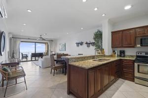 a kitchen and living room with a view of the ocean at Stunning Condo with Panoramic Beach, Ocean, and Mountain Views in Playa Flamingo in Playa Flamingo