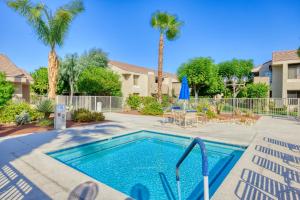 a swimming pool in a yard with palm trees at 2BR Plaza Villas Bungalow Deluxe by Oranj Palm in Palm Springs
