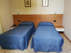 Postel nebo postele na pokoji v ubytování Albergo Salerno