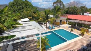 an aerial view of a villa with a swimming pool at Cabinas El Colibri, Apart Hotel in Carrillo