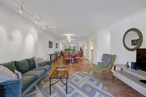 a living room with a couch and chairs and a table at Plaza Villas Posada by Oranj Palm in Palm Springs