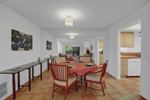 a kitchen and dining room with a table and chairs at Plaza Villas Posada by Oranj Palm in Palm Springs +26 photos