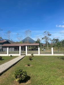a white fence in front of a building at Volcano Refuge House in Fortuna