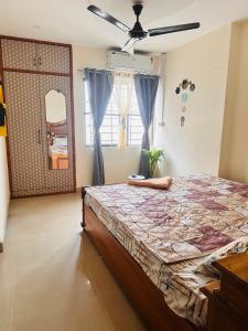 a bedroom with a bed and a ceiling fan at Elite 7 in Guwahati
