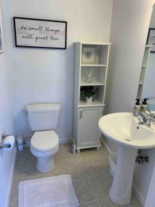 a bathroom with a toilet and a sink at 2 Bedroom Beach Condo 1 block from Ocean in Narragansett +16 photos