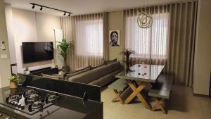a living room with a couch and a table at The Corner 1BR in Gemmayze in Beirut