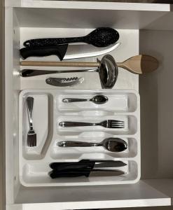 a drawer filled with utensils in a refrigerator at Sol, 1BR Gemmayze in Beirut +20 photos