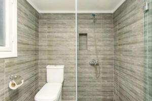 a bathroom with a toilet and a shower at Steps 1BR in Gemmayze in Beirut +12 photos
