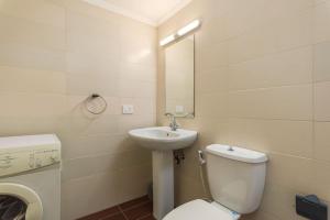 a bathroom with a toilet and a sink at Cozy Batroun Souk 2-BR Apartment in Batroûn