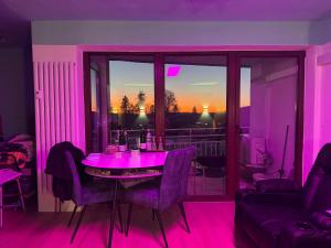 a purple room with a table with purple chairs at Bavaria Oasis in Altreichenau