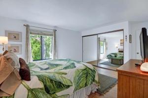 a bedroom with a bed and a large window at Palm Canyon Villas Escape in Palm Springs