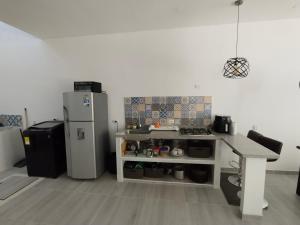a kitchen with a refrigerator and a table in it at Casa N4 in Carmen de Apicalá