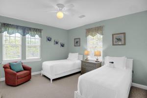 a bedroom with two beds and a chair at Martinique Vitamin Sea 10C in Gulf Highlands +78 photos