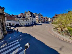an empty street with a person walking down the street at Charmant Studio 3 pers - Hyper centre d'Arras in Arras