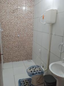 a bathroom with a shower with a toilet and a sink at Condominio Nina2 in Icapuí