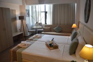 Postel nebo postele na pokoji v ubytování Aqua Mare Sea Side Rooms