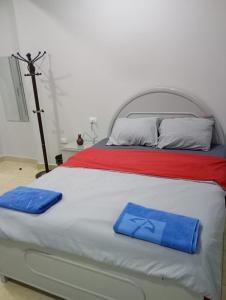 a bed with two blue towels on top of it at Abeer Guest House in Luxor +74 photos