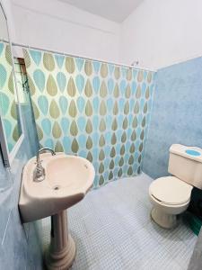 a bathroom with a sink and a toilet at Surf Casita Mexicana Next to Playa San Diego in Santiago Astata +6 photos