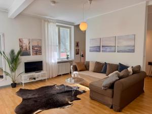 a living room with a couch and a table at Villa Centralen in Helsinki