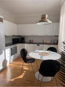 a kitchen with a table and chairs in it at Villa Centralen in Helsinki +13 photos