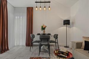 a living room with a table with chairs and a couch at Bucharest Central Apartment in Bucharest