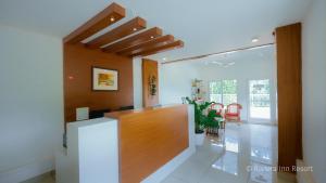 a living room with a counter and a dining room at Riviera inn resort in Chillithodu +104 photos