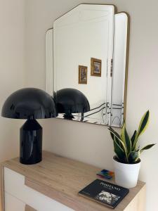 a mirror on a shelf with a potted plant at A Casa di Nonna Anna ~ Artistic Amalfitan House in Maiori