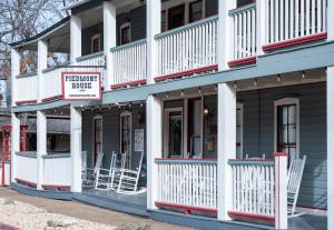 a building with a sign that reads premier homes at Downtown Secret Garden Piedmont in Eureka Springs