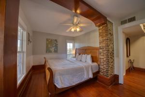a bedroom with a bed and a ceiling fan at Downtown Secret Garden Piedmont in Eureka Springs