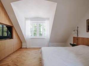 a bedroom with a white bed and a window at Pargimaja in Võru +99 photos