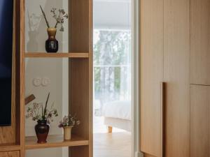 a room with a mirror with two vases on a shelf at Pargimaja in Võru