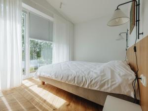 a bedroom with a bed and a large window at Pargimaja in Võru