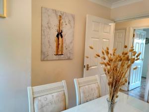 a dining room with a table and two chairs at Canalside Chic Your London Escape Starts Here WIFI and Airport Transfers in Hemel Hempstead