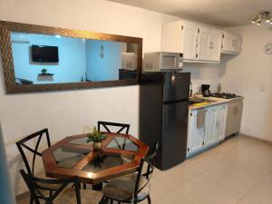 a kitchen with a table and a black refrigerator at Casa Liseto in Coyula