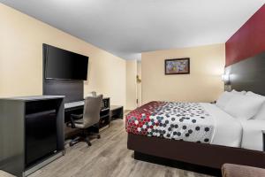 a hotel room with a bed and a desk with a computer at Econo Lodge Inn & Suites Santa Rosa in Santa Rosa