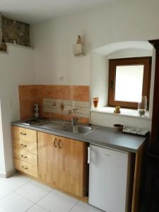 a kitchen with a sink and a window at Studio Kairos in Trogir