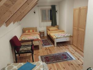 a small room with two beds and a window at Apartment Dulovine in Kolašin