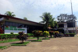 a building with trees and plants in front of it at Hotel Sol del Oriente Pucallpa in Pucallpa