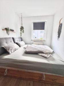 a large bed in a room with a window at Cottbus-Apartments - Grey I privat I Wifi I Küche in Cottbus